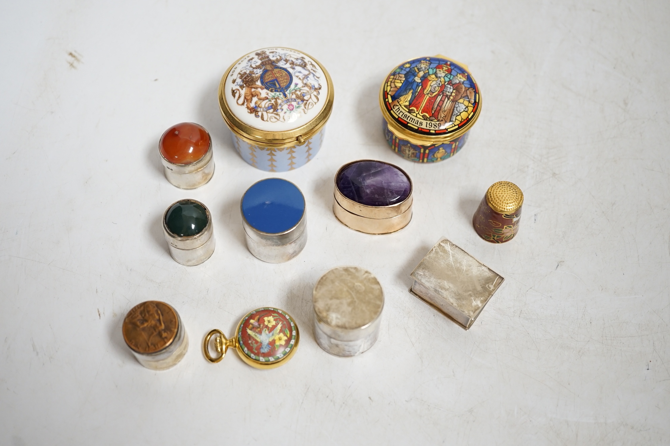 A collection of patch boxes including some silver, a gilt metal and amethyst example, Halcyon Days enamel and a miniature yellow metal love heart locket stamped 375, largest 4.5cm diameter. Condition - mostly good